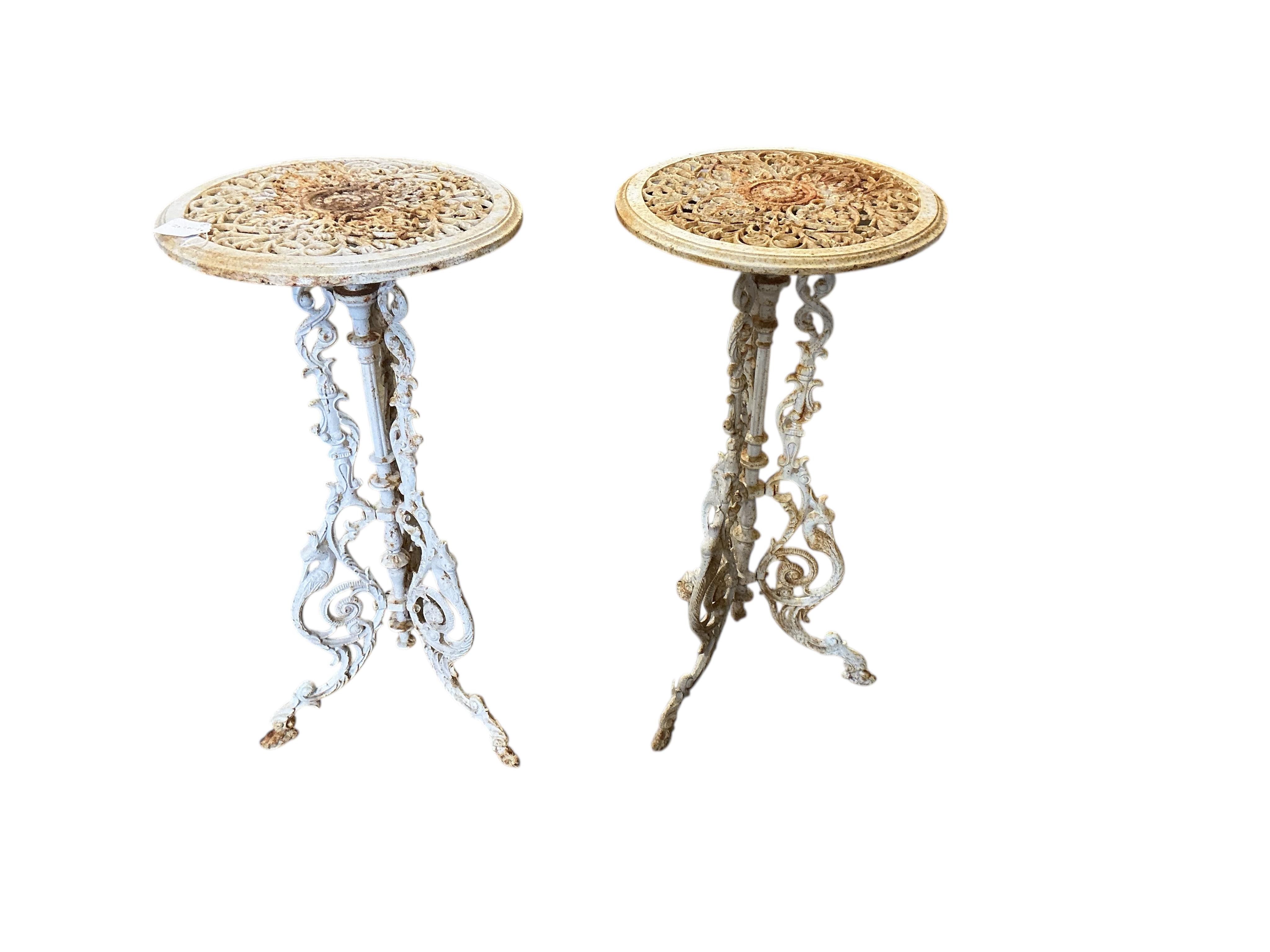 A pair of Victorian style circular painted cast iron stands, diameter 36cm, height 71cm